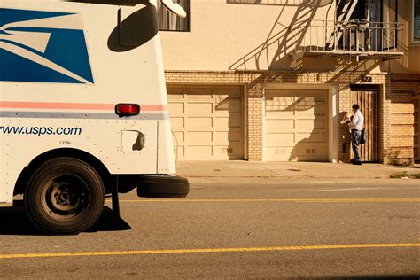 Download USPS Tracking Truck Parked During Daytime Wallpaper