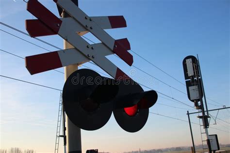 Railroad Crossing With Red Light Signal In The Low Polder In Moordrecht On Train Heading From