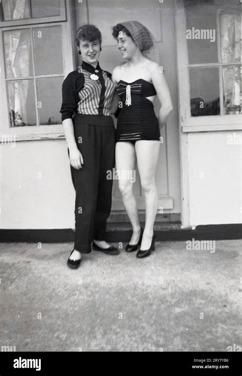 1960s, historical, two young women, sisters, standing togther for a ...