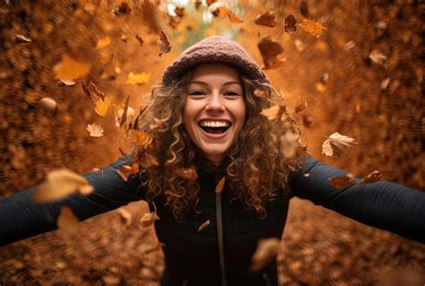 Mujer sonriente en cálidas hojas de otoño en el estilo de las