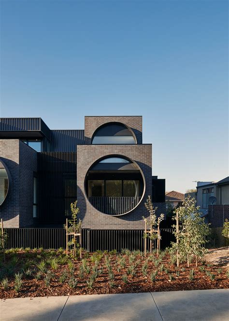 bkk architects frames cirqua apartments with oversized, circular windows