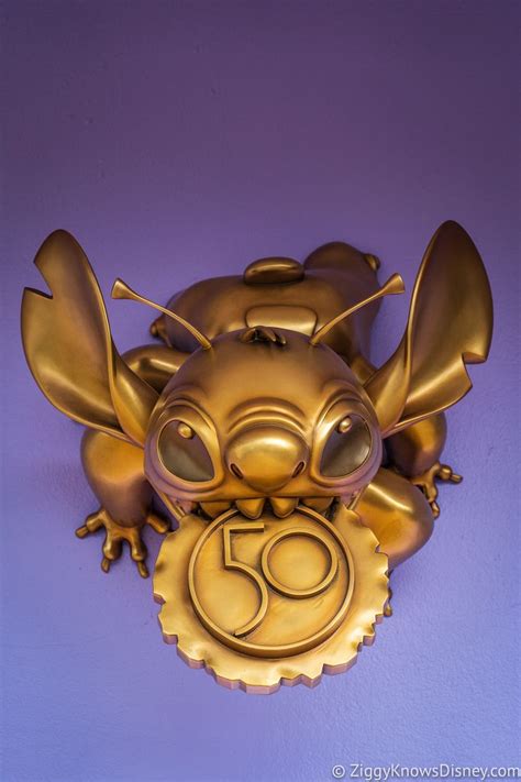 A Gold Dragon Sculpture With The Number Sixty On Its Face And Eyes