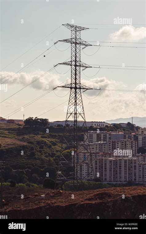 High Voltage Power Transmission Towers In Sunset Sky Background Stock