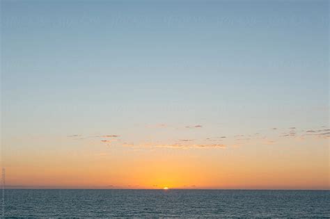 Sunset Over Calm Ocean California By Stocksy Contributor Kristin