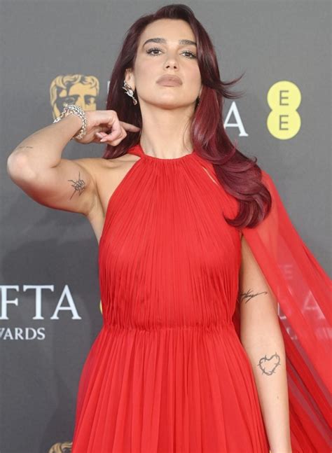 Red Haired Radiance Dua Lipa Makes Dramatic Entrance In Fiery Hot Valentino Gown At BAFTA Film