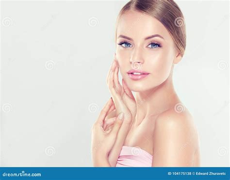 Woman With Clean Perfect Skin Beauty Model Portrait With Natural Nude Make Up And Touching Her