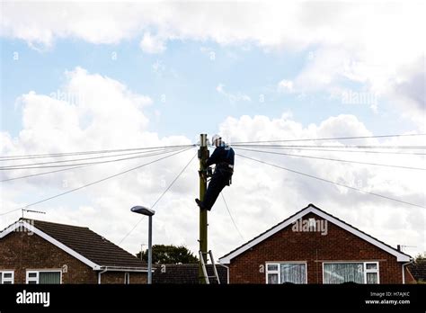 Bt Engineer Repairing Telephone Line Up Telegraph Pole Working On Line