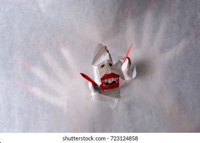 Horrifying Vampire Tearing Hole Through Paper Stock Photo