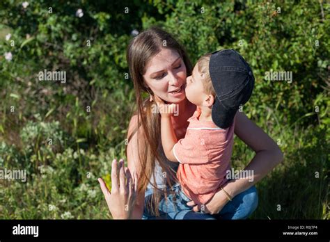 mom and young boy son play park love Stock Photo - Alamy