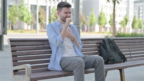 Young Man Coughing While Sitting On Bench Stock Image Image Of