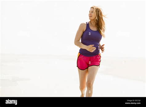 Mature Woman Jogging By Coast Stock Photo Alamy
