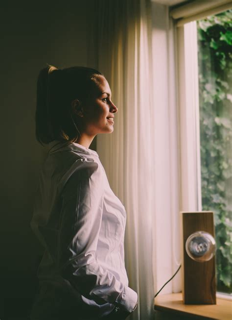 Woman Wearing White Long Sleeved Shirt Standing In Front Of The Window With White Curtain · Free