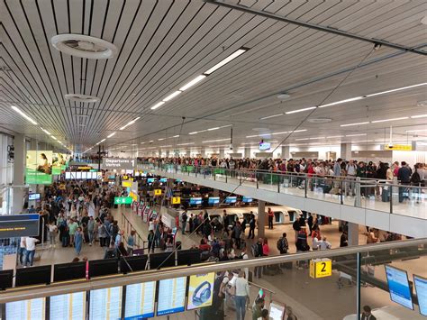 Travelers waiting in lines for security Amsterdam Schiphol 2022