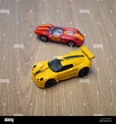 A Mattel Hot Wheels Toy Model Lotus Sport Elise And Glory Chaser Car On A Wooden Surface Stock