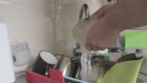 Close Up Male Hands Washing A Dirty And Greasy Plate In The Kitchen