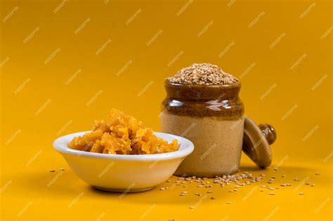 Premium Photo Sesame Seeds In Clay Pot With Jaggery In Bowl