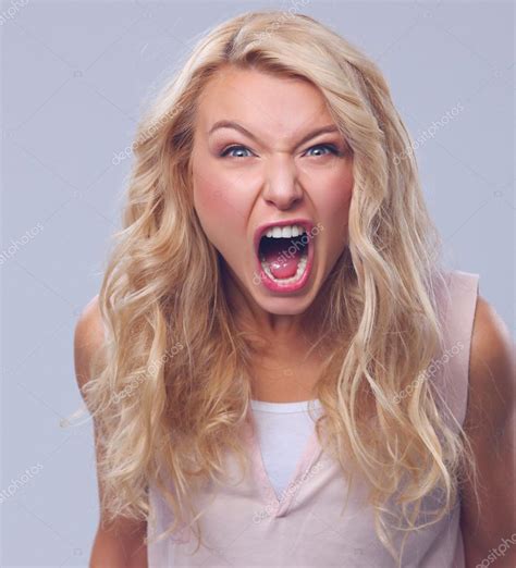 Young Angry Woman Screaming Isolated On Gray Stock Photo By