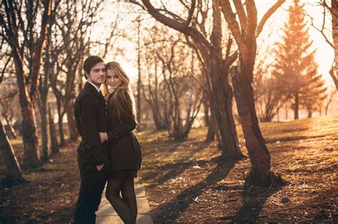 Premium Photo | Loving couple hugs and kisses at sunset in park