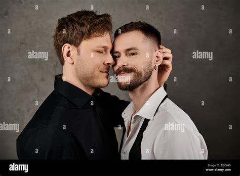 A Gay Couple In Elegant Suits Embracing In A Studio Setting Stock Photo Alamy