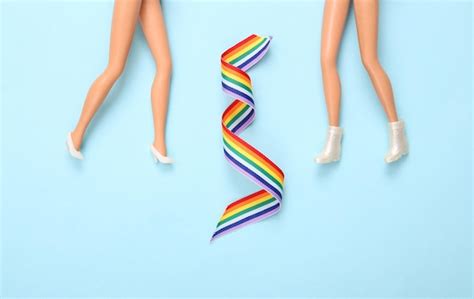 Premium Photo Lgbt Community Lesbian Relationship Concept Dolls Feet And Rainbow Lgbt Symbol