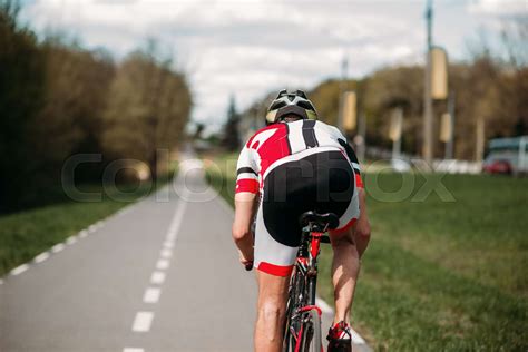 Cyclist rides on bicycle, side view | Stock image | Colourbox