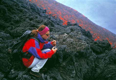 Volcanologist by lava flow - Stock Image E392/0033 - Science Photo Library