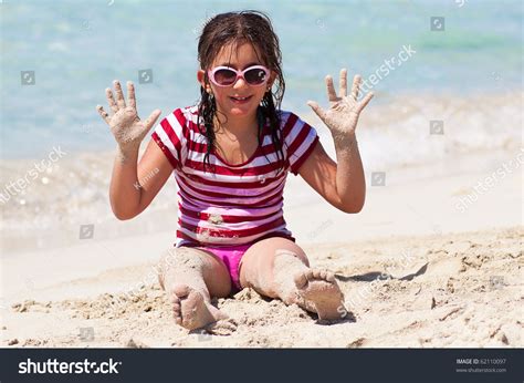 Beautiful Girl With Sunglasses Playing In The Sand On A Tropical Beach