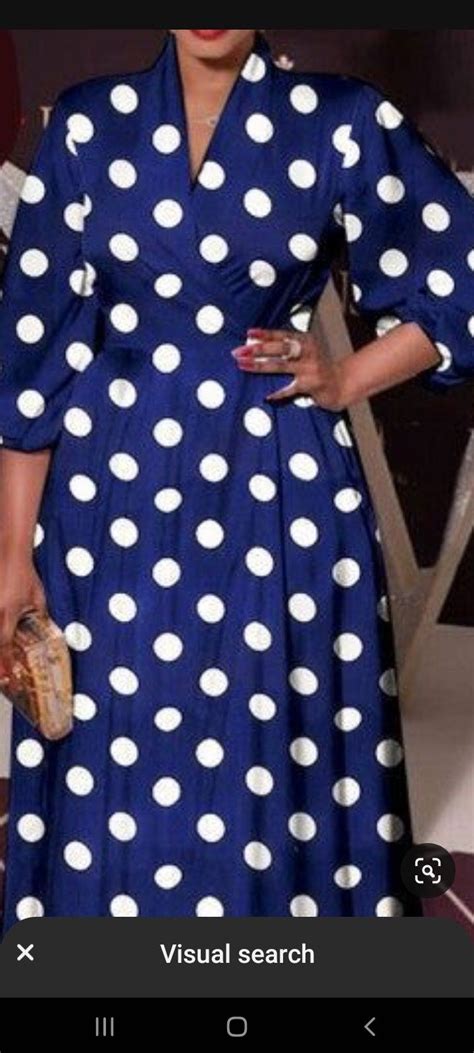 A Woman In A Blue And White Polka Dot Dress