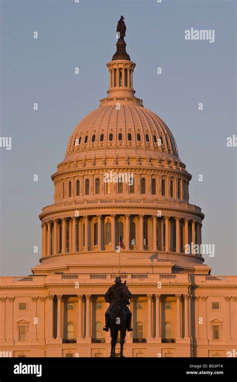 Statue In Front Of The Dome Of The Us Capitol Building Evening Light