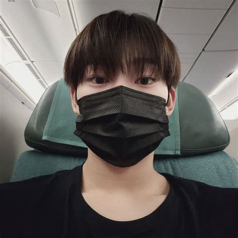 A Person Wearing A Face Mask On An Airplane