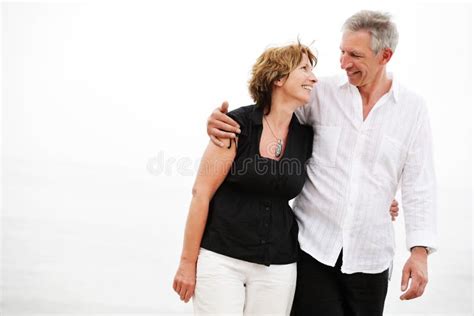 Mature Couple Walking Along The Beach Stock Photo Image Of Active Attractive 12885212
