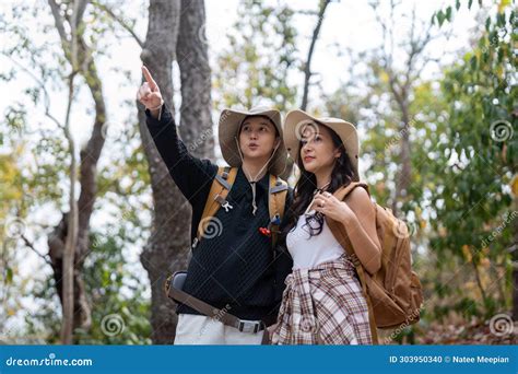 Cheerful Romantic Lesbian Couple Traveler With Backpack On Their Backs Go Hiking Through The