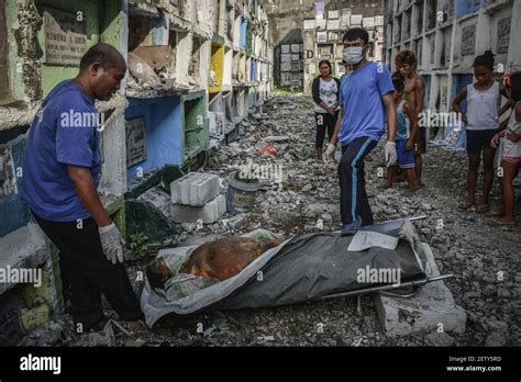 Funeral Workers Prepare To Stuff Into A Tiny Apartment Style Tomb