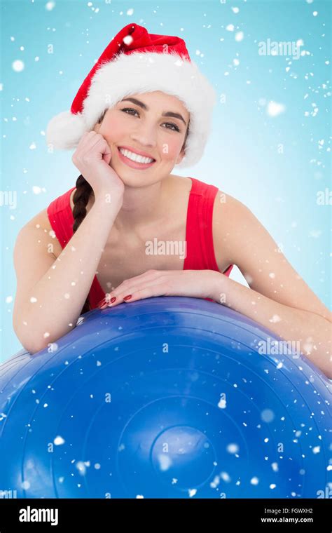 Composite Image Of Festive Fit Brunette Leaning On Exercise Ball Stock