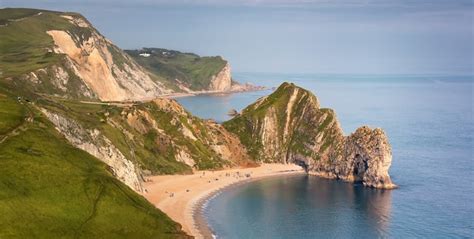 Premium Photo | Aerial view on durdle door and green fields in the ...