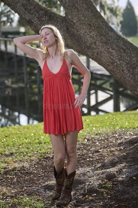 Blonde Woman In Red Dress And Cowboy Boots Stock Image Image Of Lake