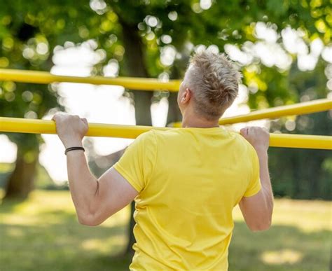 Premium Photo Man Doing Push Ups With Horizontal Bar Outdoors In Park