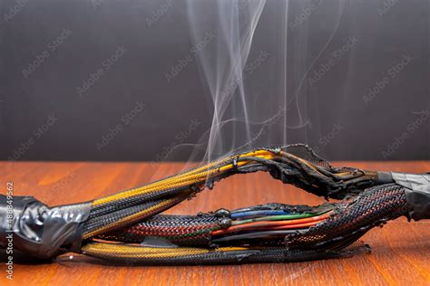 Burnt And Melted Wires Smoke On A Dark Background A Short Circuit In