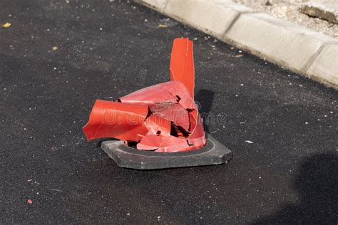 Close Up Of A Broken Orange Traffic Cone After A Severe Car Accident On