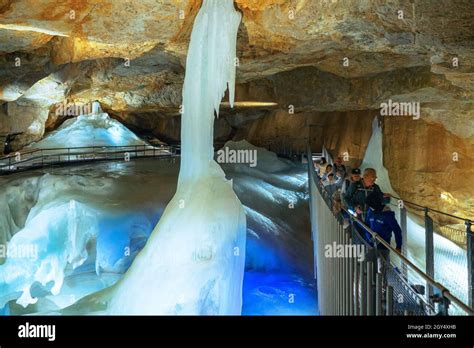 Tourists Crossing A Rope Bridge At The Tristandom Inside The Dachstein