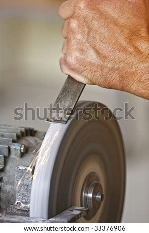 detail of classic industrial grindstone , make the tool sharp - stock photo