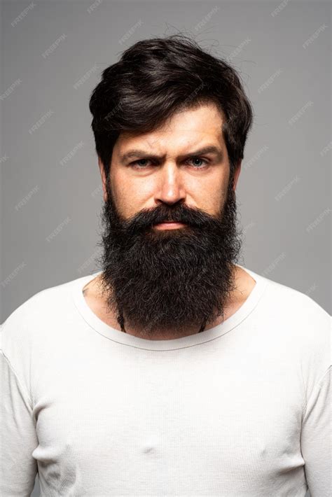 Premium Photo Portrait Of Confident Serious Man Has Beard And Mustache Looks Seriously