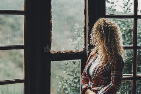 One Woman Standing Alone at Home Looking Outside the Windows at Nature ...