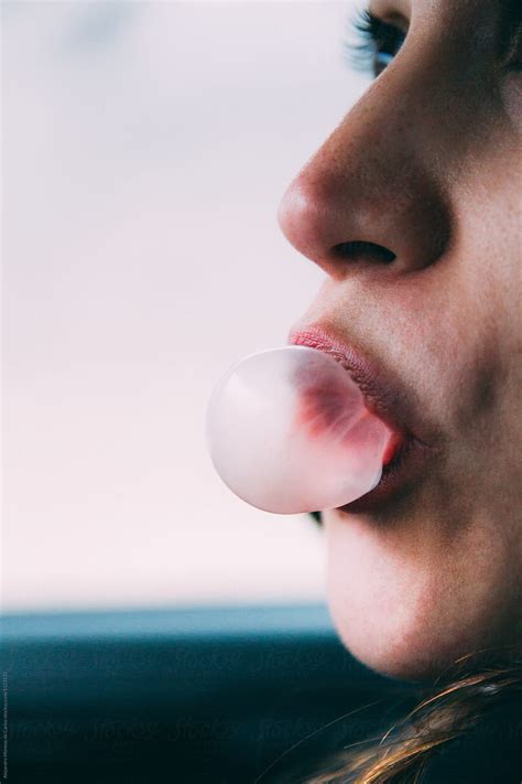 Woman Blows A Bubble Of Pink Gum By Stocksy Contributor Alejandro