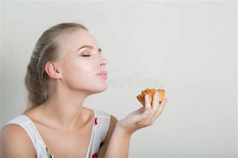 Playful Blonde Woman Having Fun With A Sweet Dessert With Nuts Stock Photo Image Of Holding