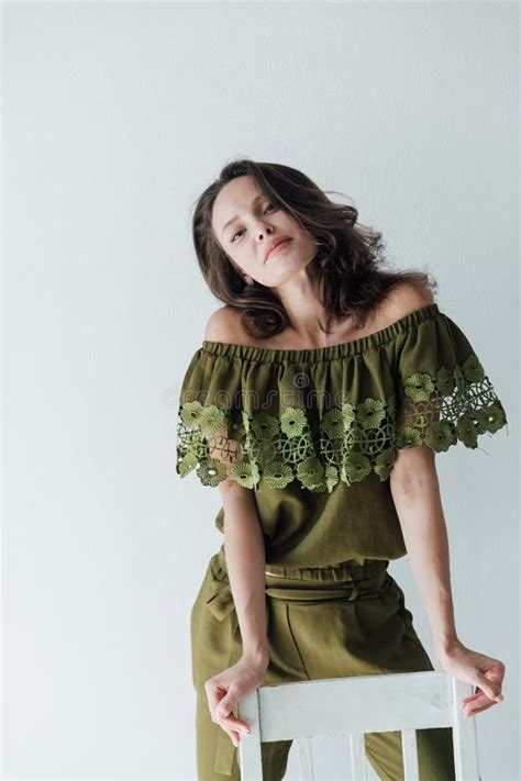 Beautiful Fashionable Slim Brunette Woman Sitting On A Chair And Smiling Stock Photo Image Of