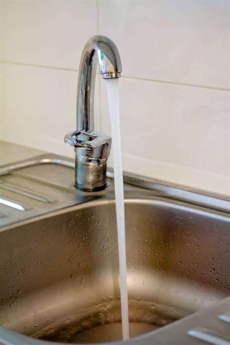 Running water from a tap stock photo. Image of clear - 83735980