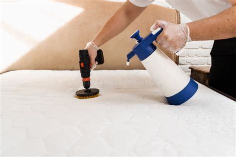 Spraying And Smearing Detergent On White Mattress Using Drill With