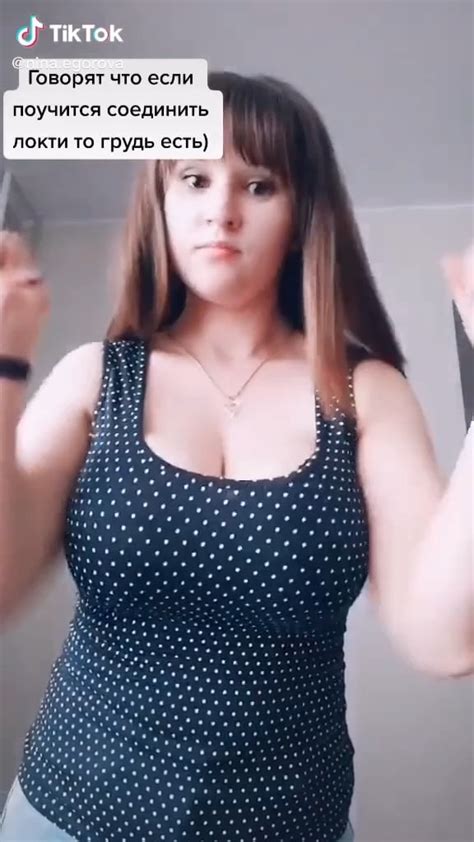 Tiktok User Ninaegorova Squeezing Her Clothed Boobs Together With Her Arms Showing Her