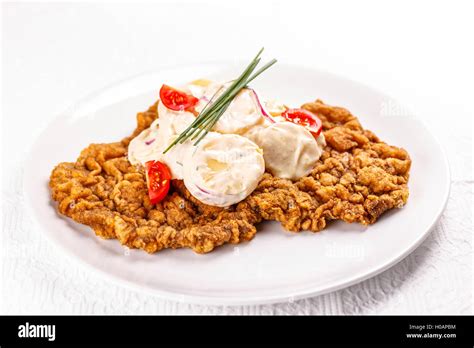 Large wiener schnitzel with potatoes salad Stock Photo - Alamy